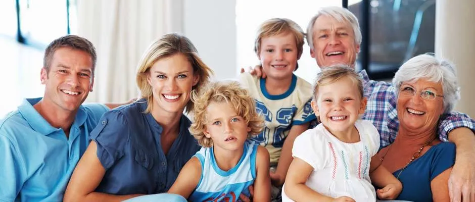 Portrait of happy multi generation family smiling together on couch